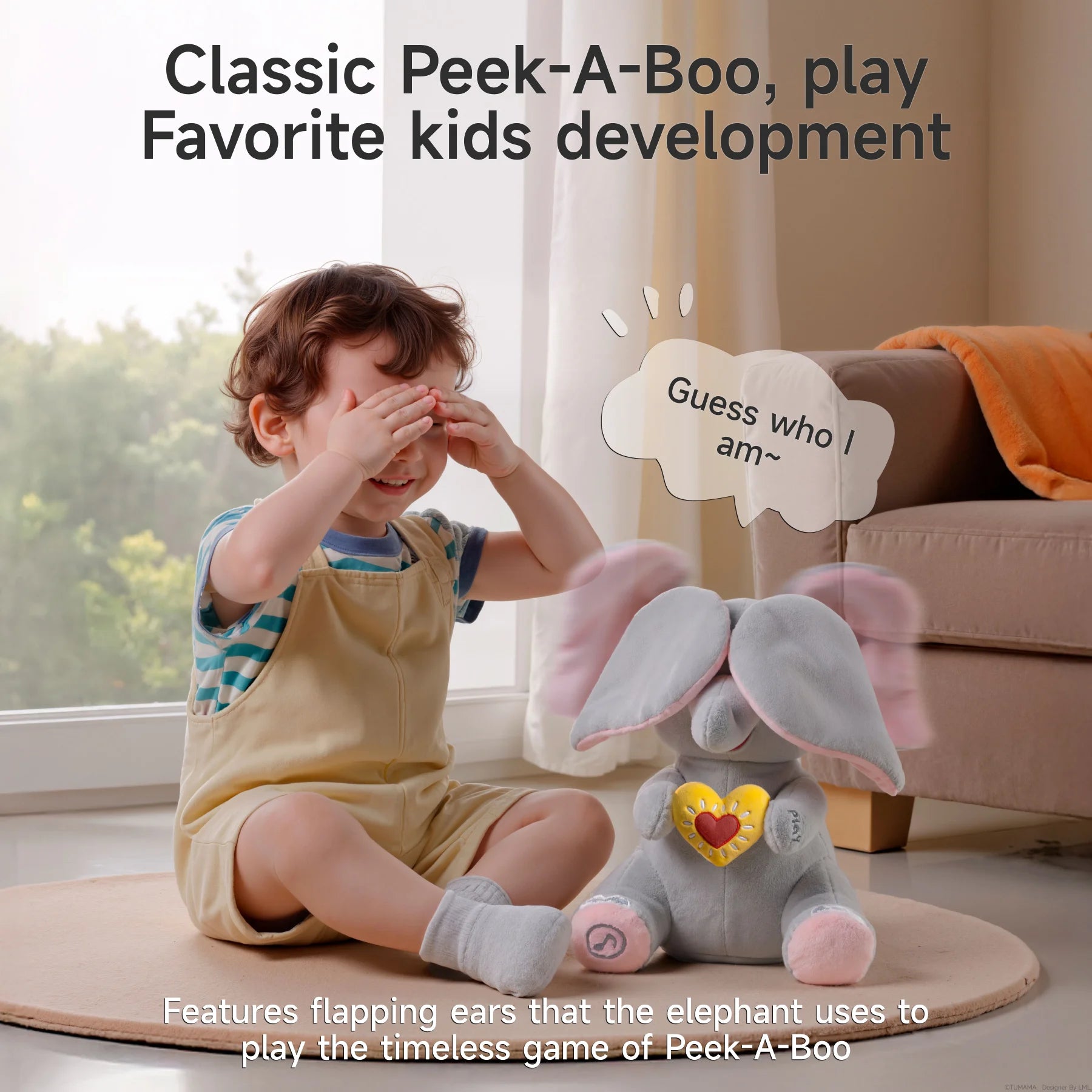 A young child sitting on the floor playing peek-a-boo with an interactive elephant plush toy. The elephant is covering its eyes with its large floppy ears, and a speech bubble says, 'Guess who I am~'. Text above reads: 'Classic Peek-A-Boo, play – Favorite kids development', and a caption below explains that the toy features flapping ears to play the timeless game of Peek-A-Boo.