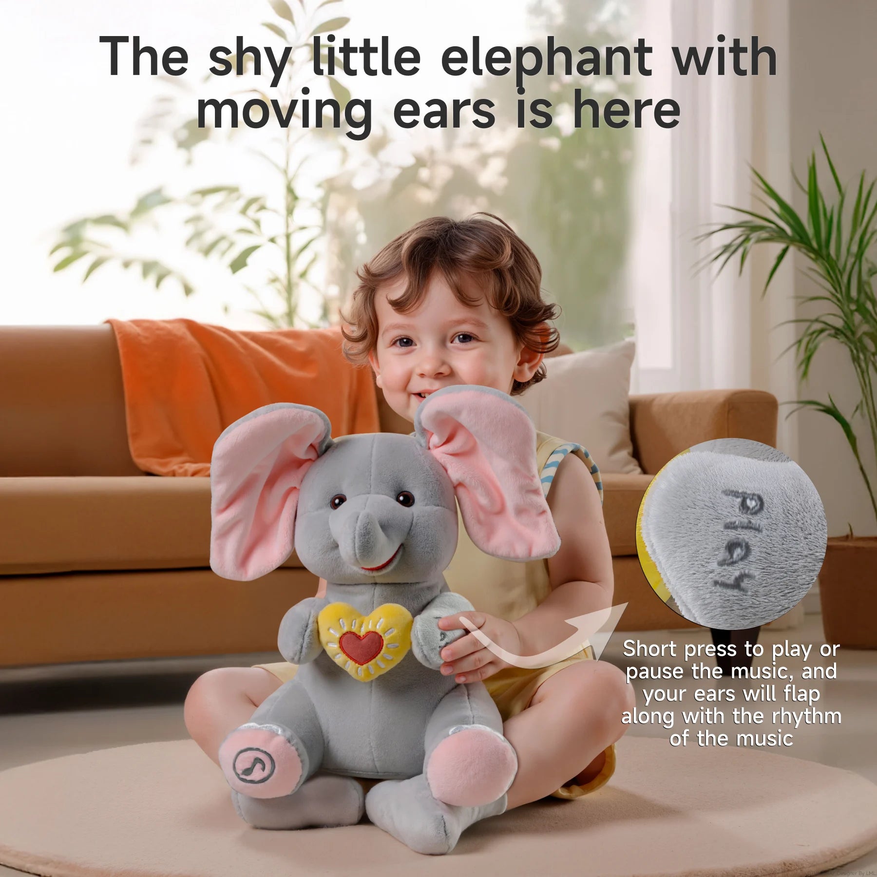 A happy child sitting on the floor, hugging an interactive elephant plush toy with large pink ears. The elephant is holding a yellow heart and has the word 'play' embroidered on its hand. An inset shows a close-up of the 'play' button. Text reads: 'The shy little elephant with moving ears is here.' A note explains: 'Short press to play or pause the music, and your ears will flap along with the rhythm of the music.