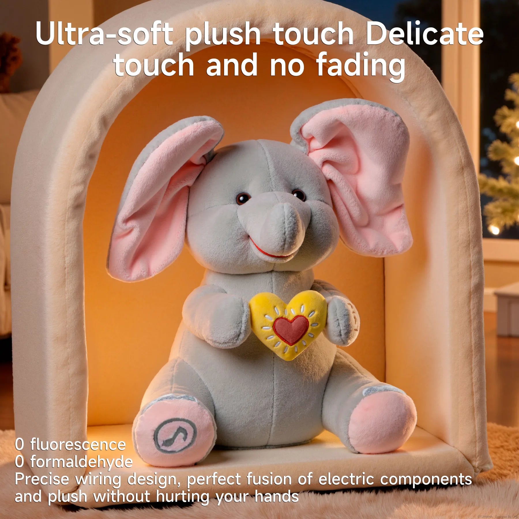 Interactive elephant plush toy with pink ears and a yellow heart sits inside a cozy arch-shaped setting. Text above reads: 'Ultra-soft plush touch, delicate touch and no fading.' Additional text below highlights safety and quality: '0 fluorescence, 0 formaldehyde. Precise wiring design, perfect fusion of electric components and plush without hurting your hands.'