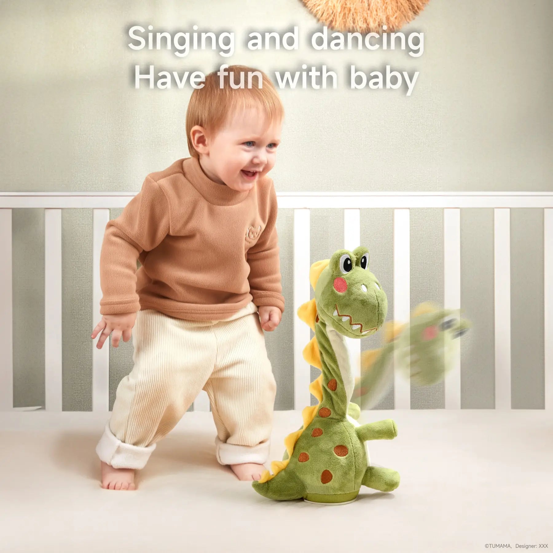 A smiling toddler dances alongside a green singing and dancing dinosaur toy. The toy features a playful design with orange spots, rosy cheeks, and cheerful movements, making it a fun and interactive playtime companion.