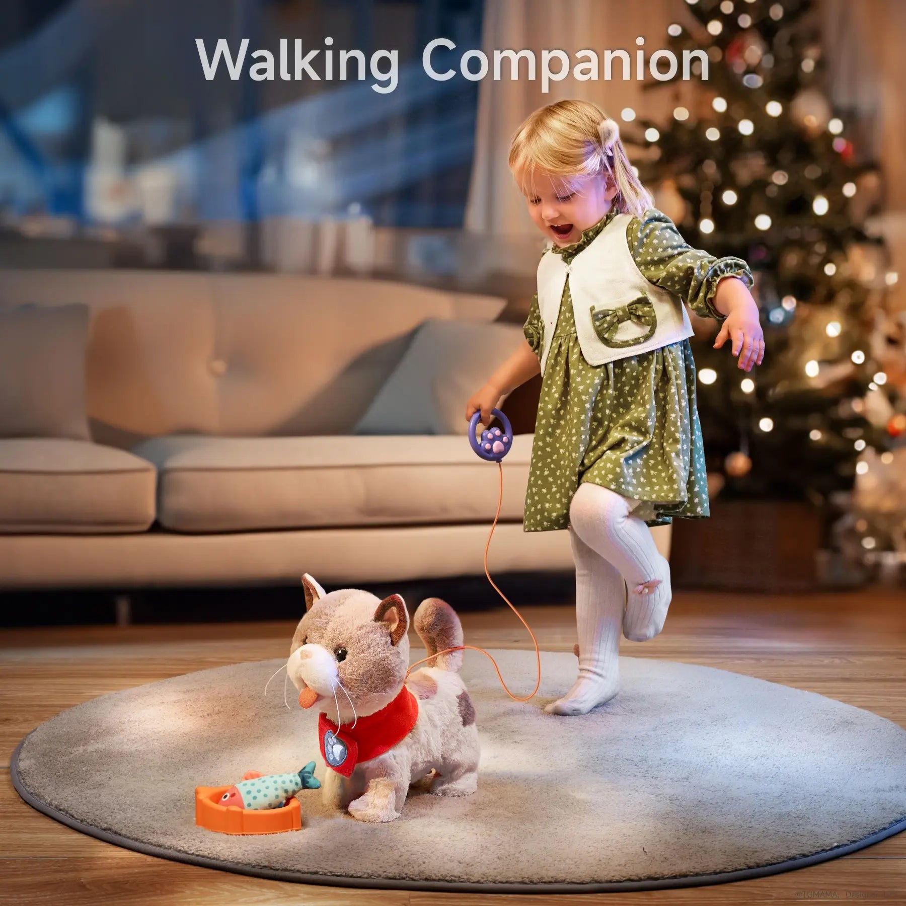 A young girl walking an interactive toy kitten using a paw-shaped leash remote. The kitten is on a rug with its toy fish in a food bowl, creating a lifelike and fun playtime experience.