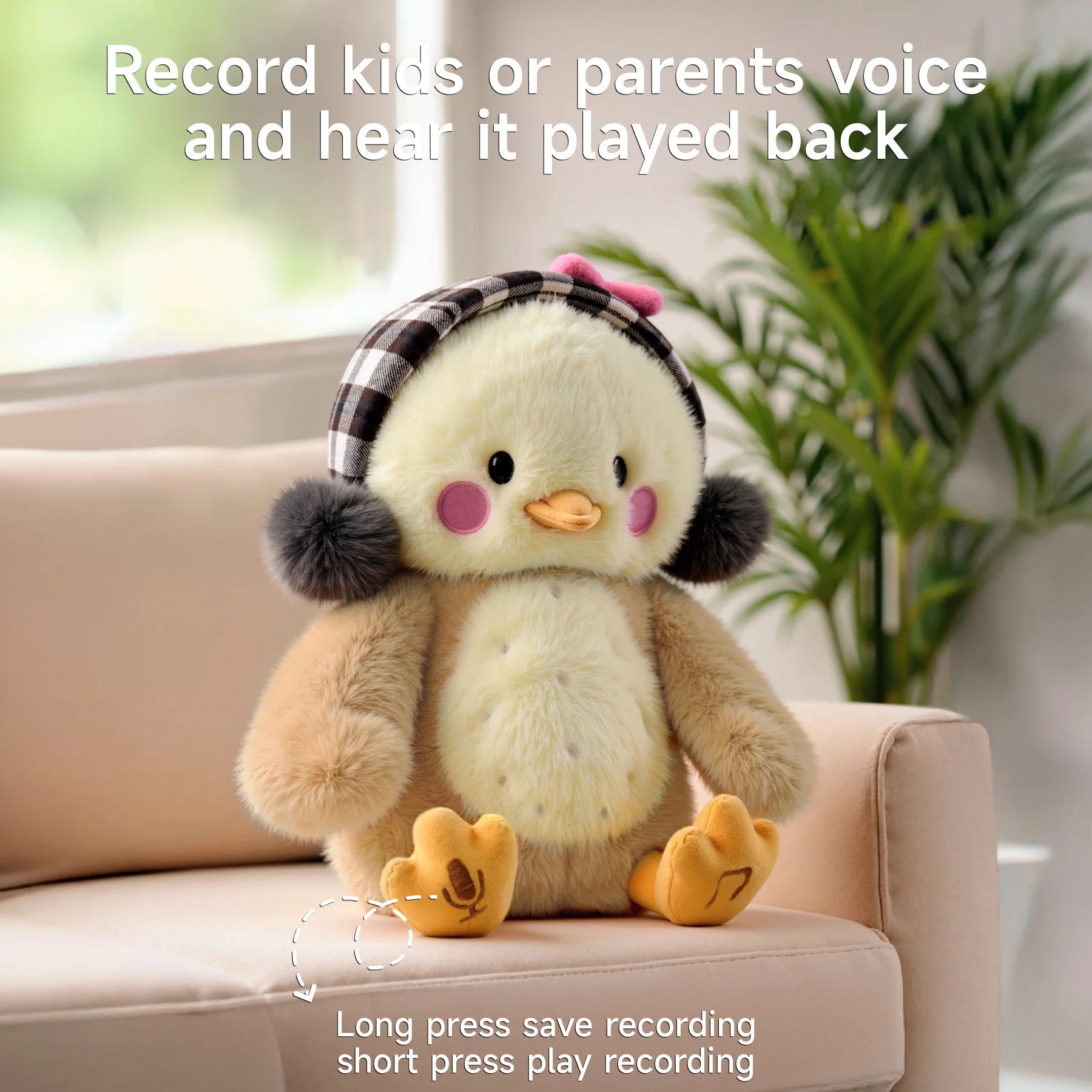A cute interactive plush chick toy with pink cheeks, plaid earmuffs, and a pink bow, sitting on a beige sofa. Text above reads ‘Record kids or parents voice and hear it played back.’ The chick’s left foot has a microphone symbol with instructions below: ‘Long press save recording, short press play recording.’