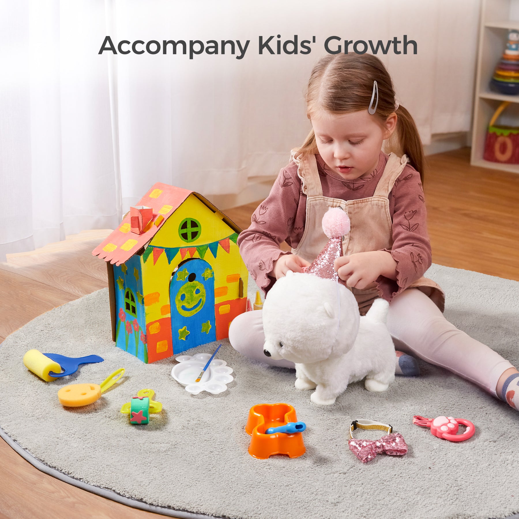 A young girl playing with a plush puppy wearing a pink party hat alongside a colorful DIY playhouse. The set includes painting supplies, a food bowl, and dress-up accessories, offering interactive and creative playtime.