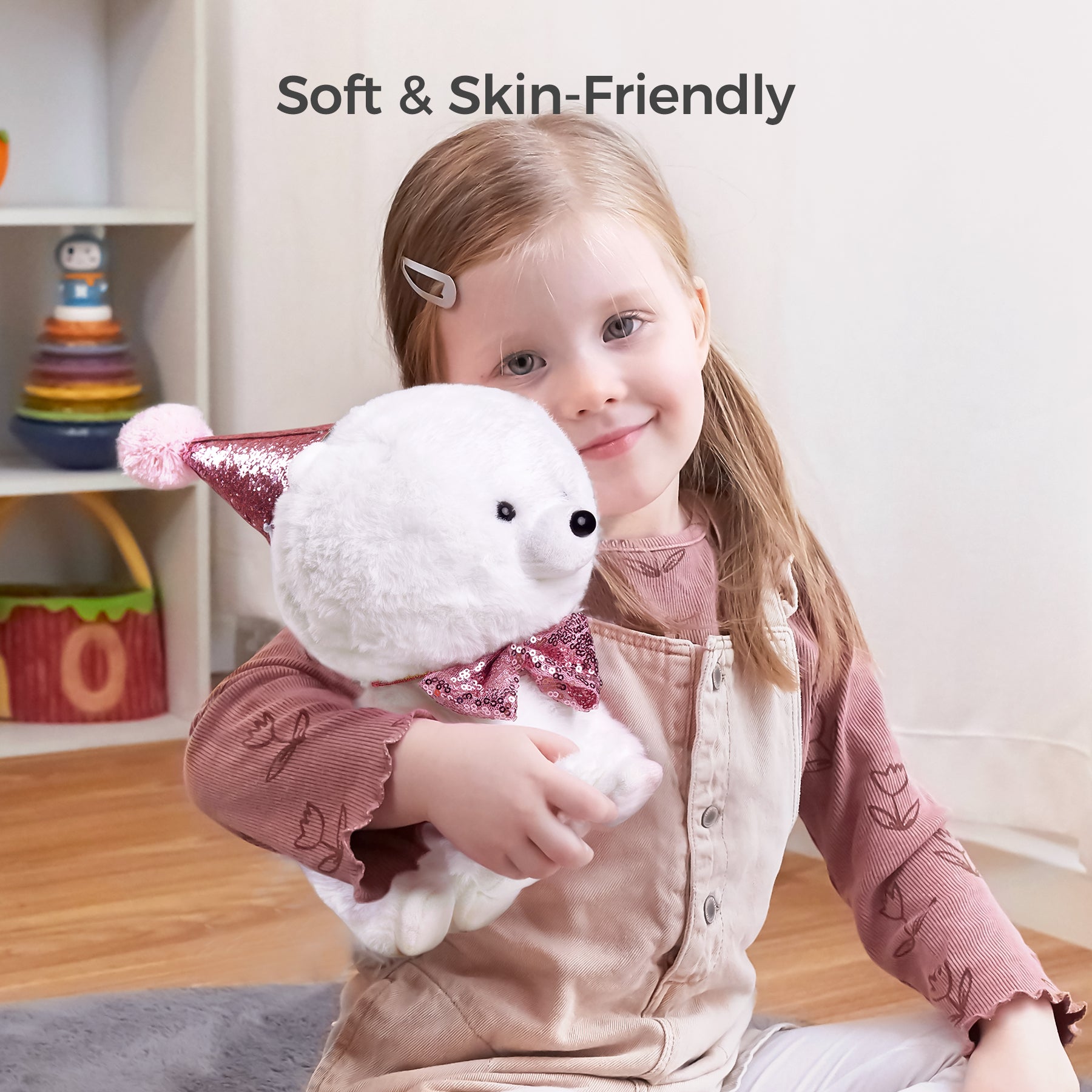 A smiling young girl cuddling a soft, skin-friendly plush puppy dressed in a sparkly pink bowtie and party hat. Perfect for hugs and companionship, this toy ensures comfort and joy for kids.