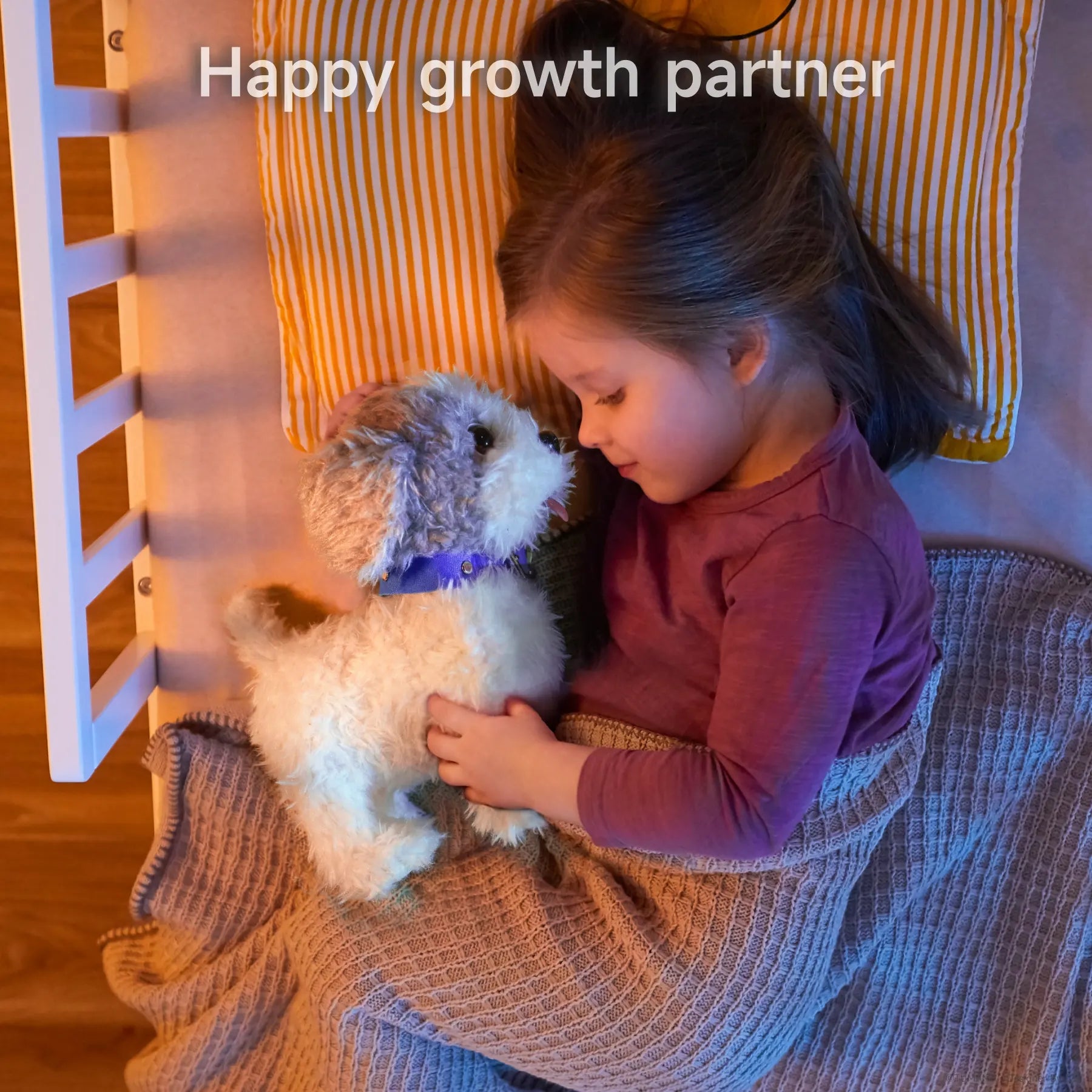 A young child cuddling a gray-and-white plush puppy toy while lying in bed. The child is covered with a cozy blanket and rests on a striped pillow, creating a warm and comforting bedtime scene. The toy serves as a happy growth partner for kids.