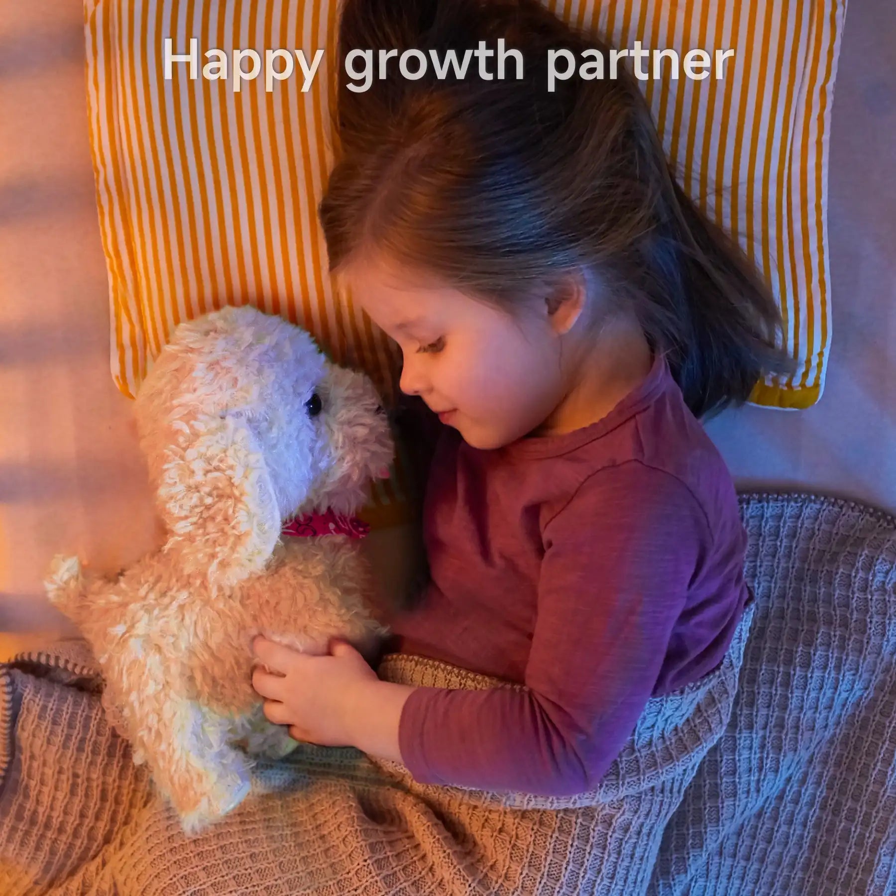 A young girl cuddling a soft plush puppy toy while lying in bed under a cozy blanket. The toy dog, wearing a red bandana, serves as a comforting companion for bedtime.