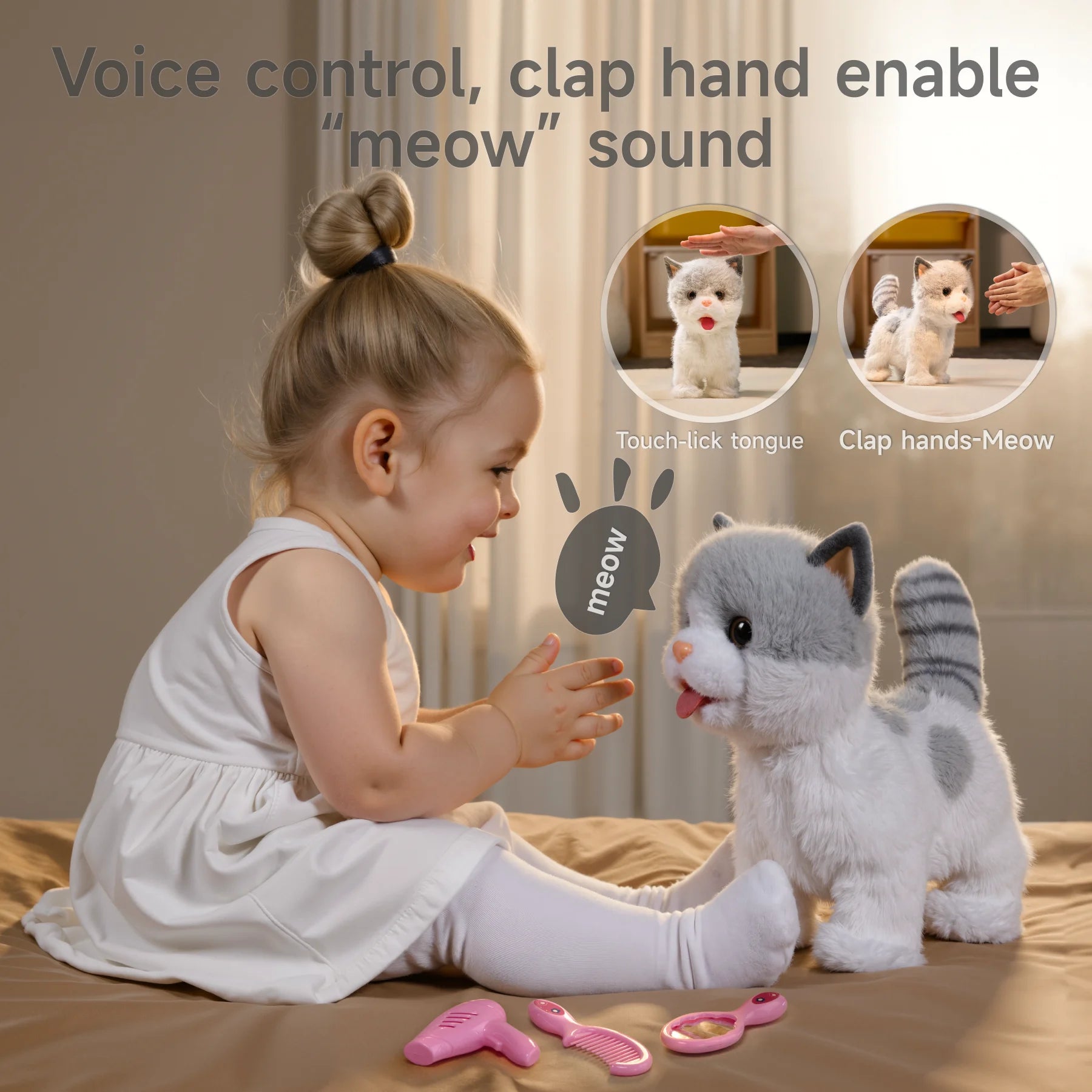 A young child clapping hands in front of an electric stuffed cat toy, which responds with a