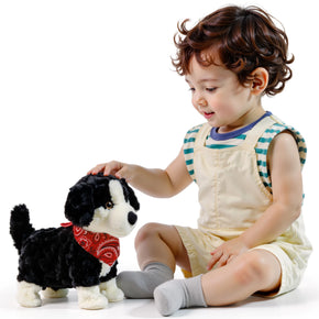 Young child playing with voice-controlled interactive plush puppy toy that walks, barks, sits, and sings – soft electronic pet dog for kids.
